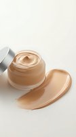 Luxury foundation cream jar with smooth beige makeup smear on neutral background for cosmetic skincare and beauty product advertising.