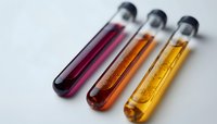 Laboratory test tubes containing colorful liquid samples in red, orange and yellow arranged diagonally on white surface, shallow depth of field for scientific research.