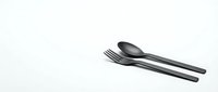 Black modern cutlery set with fork and spoon on white background. Minimalist kitchen utensils isolated for restaurant branding and culinary design projects.