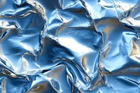 Shiny blue metallic foil texture with crumpled surface and light reflections creating dynamic abstract pattern for luxury packaging design.