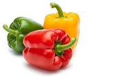Fresh colorful bell peppers red yellow green isolated on white background for healthy cooking recipes and organic vegetable designs.