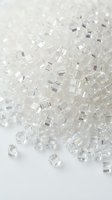 Transparent glass cubes scattered on white surface with soft focus and shallow depth of field, suitable for abstract backgrounds, design elements, and luxury product presentations.