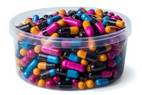 Colorful pharmaceutical capsules and pills in clear plastic container, featuring vibrant pink, blue, orange, and black medications arranged in circular pattern.