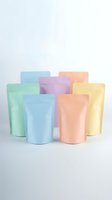 Colorful pastel stand-up pouches in mint green, blue, pink, purple and yellow arranged on white background for eco-friendly packaging and branding design.