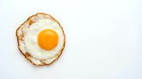 Fried egg with golden yolk and crispy edges isolated on white background for breakfast menu design and culinary projects.