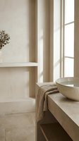 Minimalist bathroom interior with neutral beige tones, featuring a floating vanity with ceramic sink, natural linen textiles, dried botanical decor, and soft window light for spa and wellness design projects.