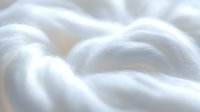 Soft white fluffy cotton texture background with gentle waves and folds creating dreamy minimalist surface pattern for luxury spa, wellness and skincare designs.