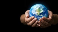 Hands holding glowing planet Earth against dark background, symbolizing environmental protection, sustainability, and global responsibility for conservation efforts.