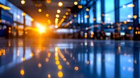 Abstract blurred urban interior with golden light reflections on glossy floor, creating atmospheric bokeh effect in modern building.