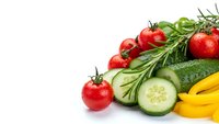 Fresh organic vegetables with cherry tomatoes, cucumber slices, yellow bell pepper and rosemary herbs isolated on white background for healthy cooking.