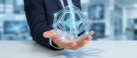 Businessman holding glowing digital network sphere with connected nodes representing global connectivity and data exchange in modern office environment.