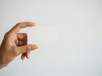 Close-up of a male hand with medium skin tone making a small gesture against a neutral white background, suitable for business, communication, and design projects.