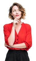 Thoughtful young woman with short wavy hair in red blouse looking up with hand on chin against white background, expressing contemplation and curiosity.