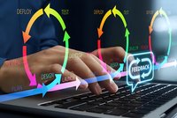 Software development lifecycle concept with hands typing on laptop keyboard surrounded by colorful arrows and tech workflow labels on dark background.