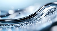 Dynamic water wave with crystal clear droplets creating elegant curves against light blue background, macro photography showing liquid motion and surface tension.