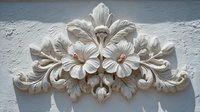Ornate floral carved stone relief with hibiscus flowers and decorative leaves on textured wall background for architectural design projects.