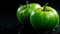Fresh green tomatoes with water droplets on dark surface for healthy cooking and organic farming concepts.