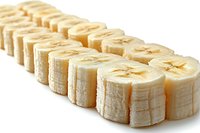Fresh sliced banana pieces arranged in row on white background, showing cross sections of ripe fruit. Clean isolated food photography for culinary designs.