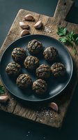Homemade herb-crusted meatballs on dark plate with garlic and parsley on rustic wooden cutting board for cooking and recipe content.
