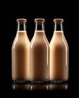 Three glass bottles filled with creamy chocolate milk beverage on black background with reflection for dairy product marketing and food advertising.
