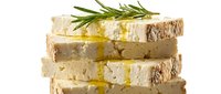 Stacked slices of artisan bread with olive oil drizzle and fresh rosemary garnish, ideal for food styling, culinary blogs, restaurant menus, and gourmet cooking content.