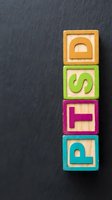Wooden blocks stacked vertically spelling DSFP in colorful frames on dark textured background, representing business concepts and organizational themes.