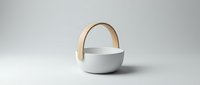 Modern white ceramic bowl with wooden handle on neutral background for kitchen and dining decor applications.