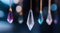 Crystal pendants hanging on chains against blurred blue bokeh background, mystical gemstone decorations with soft focus lighting effects and dreamy atmosphere.