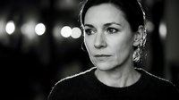 Elegant middle-aged Caucasian woman with sophisticated expression in black and white portrait photography with bokeh lights background for professional use.