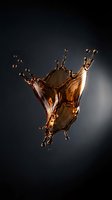 Liquid amber splash frozen in motion against dark background, isolated for beverage, cosmetic, and product advertising design use.