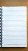 Open spiral notebook with blank lined pages on wooden desk surface for writing notes, journaling, planning and office work tasks.