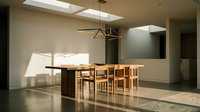 Minimalist dining room with wooden table, natural chairs, and geometric pendant light fixture casting shadows on polished concrete floor in modern interior space.