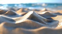 Gentle waves of golden sand with water droplets glistening in warm sunlight, creating a serene beach landscape at sunset.