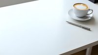 Clean white desk workspace with coffee cup and pen for business productivity and office organization.