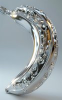 Luxurious silver banana-shaped sculpture adorned with diamonds and intricate swirling patterns on metallic surface against gray background, featuring elegant jewelry design.