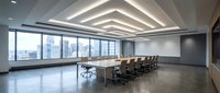 Modern corporate boardroom with geometric ceiling lights and city skyline view through floor-to-ceiling windows for business meetings and presentations.