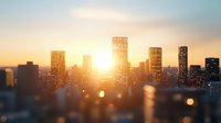 Modern city skyline silhouette at golden sunset with sun rays shining through skyscrapers, creating dreamy bokeh effect in foreground, urban landscape background.