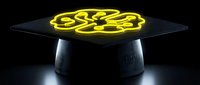 Futuristic holographic display projecting glowing yellow brain neural network on sleek black device against dark background for technology presentations.