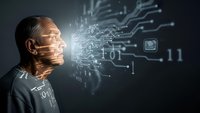Middle-aged Caucasian man with digital circuit patterns projected on face surrounded by glowing binary code and technological elements on dark background.