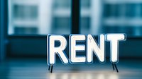 Glowing neon rent sign against blurred urban background with modern buildings, white illuminated letters on dark blue atmosphere for real estate concept.