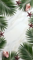 Tropical frame with palm leaves, starfish and seashells on white marble background for summer vacation design and travel promotional materials.
