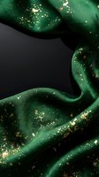 Luxurious emerald green silk fabric with golden glitter sparkles flowing elegantly on dark background for premium fashion and textile design projects.