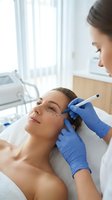 Young woman receiving botox injection treatment from professional cosmetologist in modern medical clinic for facial rejuvenation and anti-aging skincare.