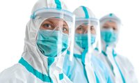 Medical workers in protective suits, face masks and shields standing in row. Focus on female healthcare professional in PPE during pandemic outbreak.