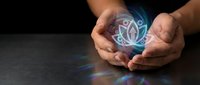 Hands gently holding glowing holographic lotus flower symbol with ethereal light rays on dark background for meditation and spiritual wellness concepts.