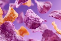 Colorful purple and orange potato chips floating on vibrant background. Crispy snack food pieces in motion for packaging and advertising designs.