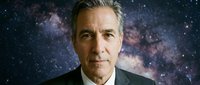Middle-aged man with gray hair and light complexion wearing formal dark suit against cosmic galaxy starfield background for science, leadership, vision concepts.