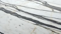 Elegant white marble surface with dramatic black veining patterns and natural stone texture for luxury interior design and architectural applications.
