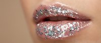 Closeup of lips with shimmering glitter makeup, sparkly cosmetic product applied for beauty and fashion styling.