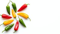 Colorful hot chili peppers arranged in circular pattern on white background. Fresh spicy vegetables in red, yellow and green colors for cooking and seasoning.